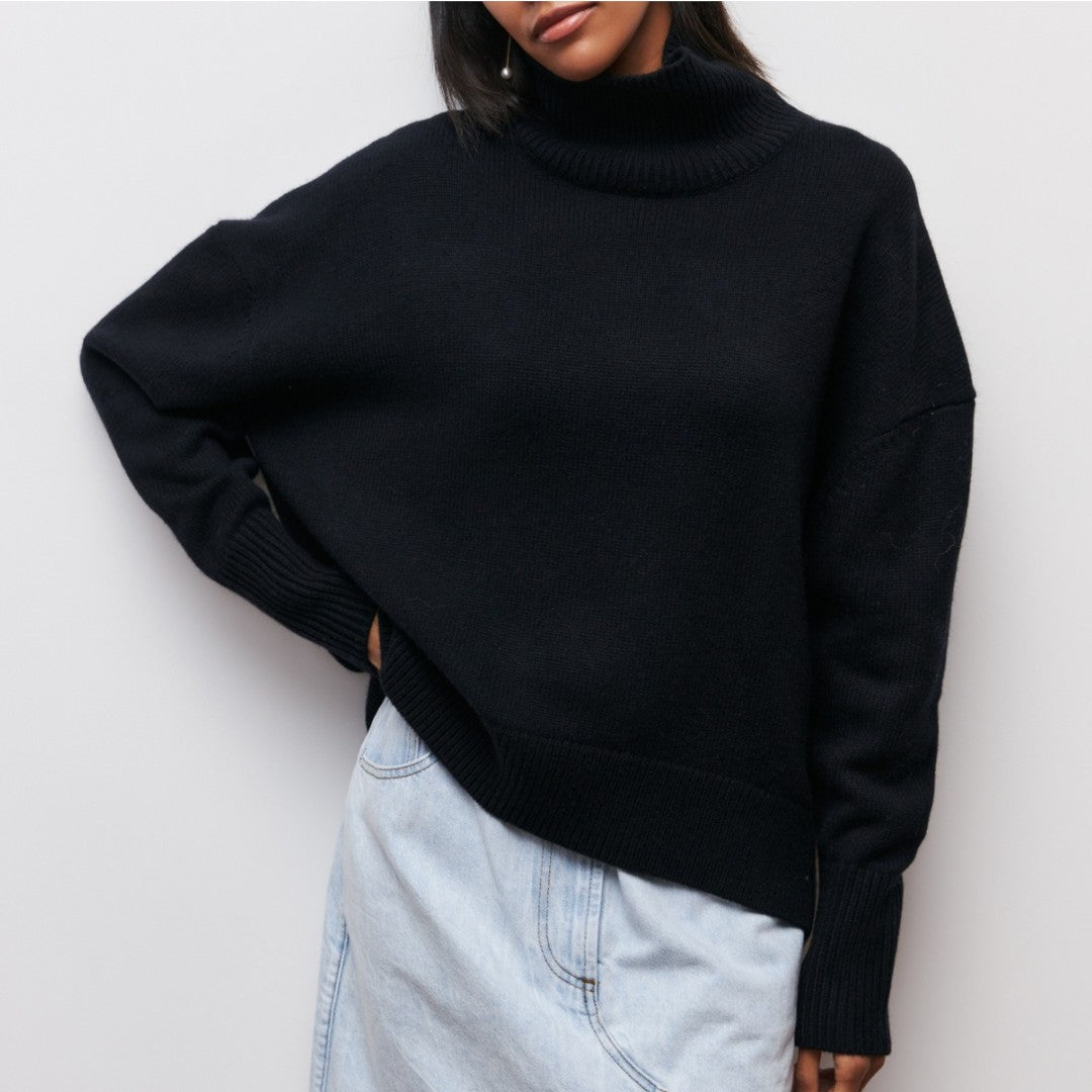 Lydia turtleneck sweater in black, worn loose over light denim