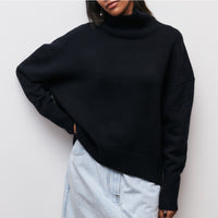 Lydia turtleneck sweater in black, worn loose over light denim