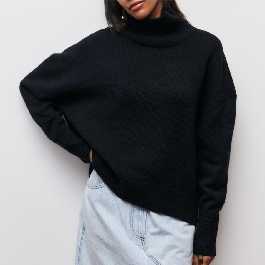 Lydia turtleneck sweater in black, worn loose over light denim