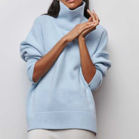 Lydia turtleneck sweater in light blue, hands resting at the high neck
